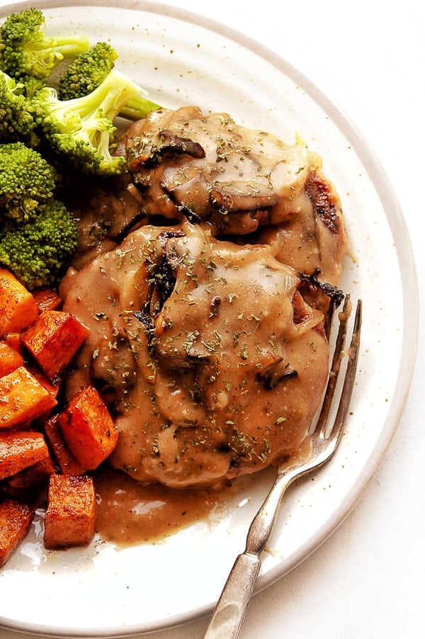 homemade Salisbury Steak with gravy and vegetables on plate 