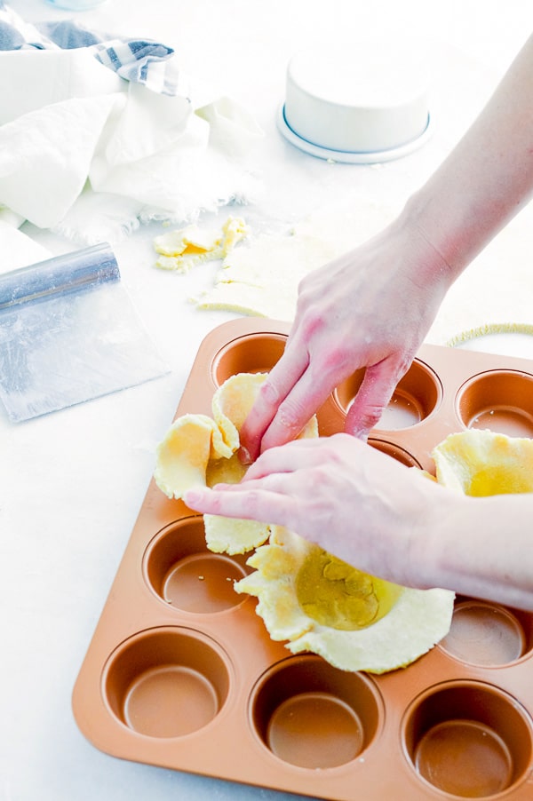 adding crust to muffin tins for mini beef pot pies 