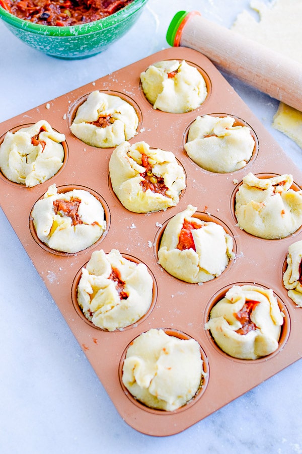 prepared mini pot pies in muffin tin before cooking