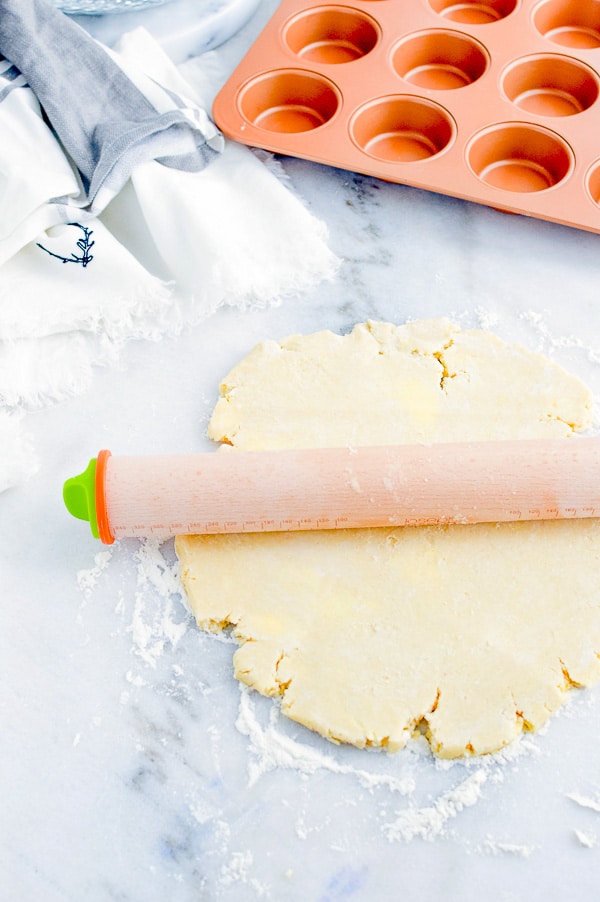 rolling out pie crust for mini beef pot pies 