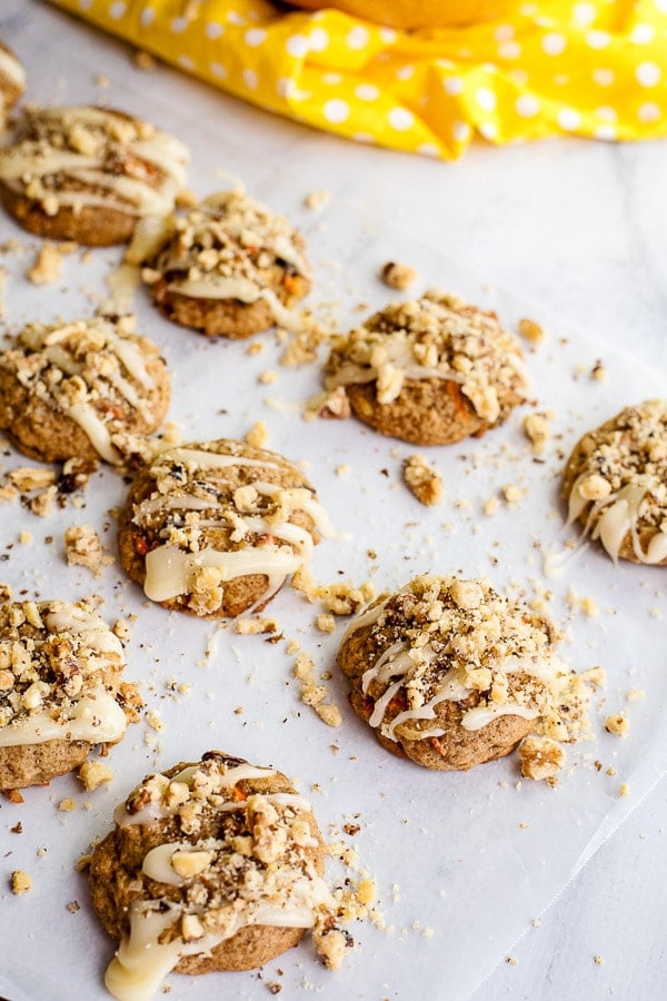 Carrot Cake Cookies drizzled with cream cheese frosting and crushed walnuts