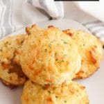 Freshly baked Cheddar Bay Biscuits on a white plate