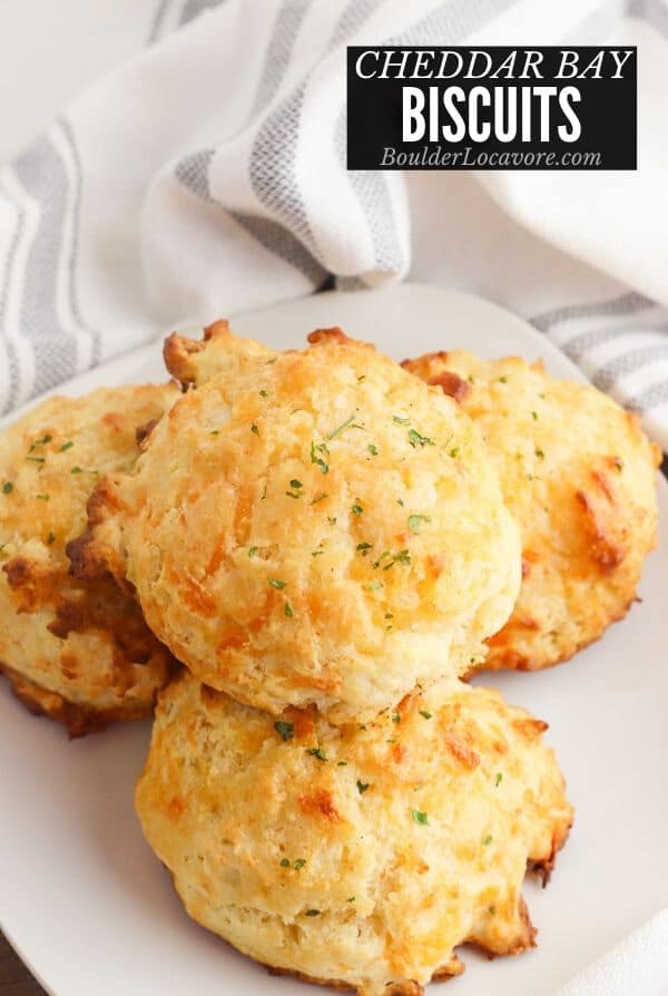 Freshly baked Cheddar Bay Biscuits on a white plate