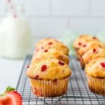 strawberry muffins on cooling rack with title text