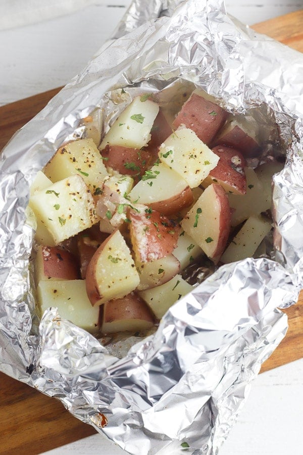 foil packets of cooked red potatoes with herbs