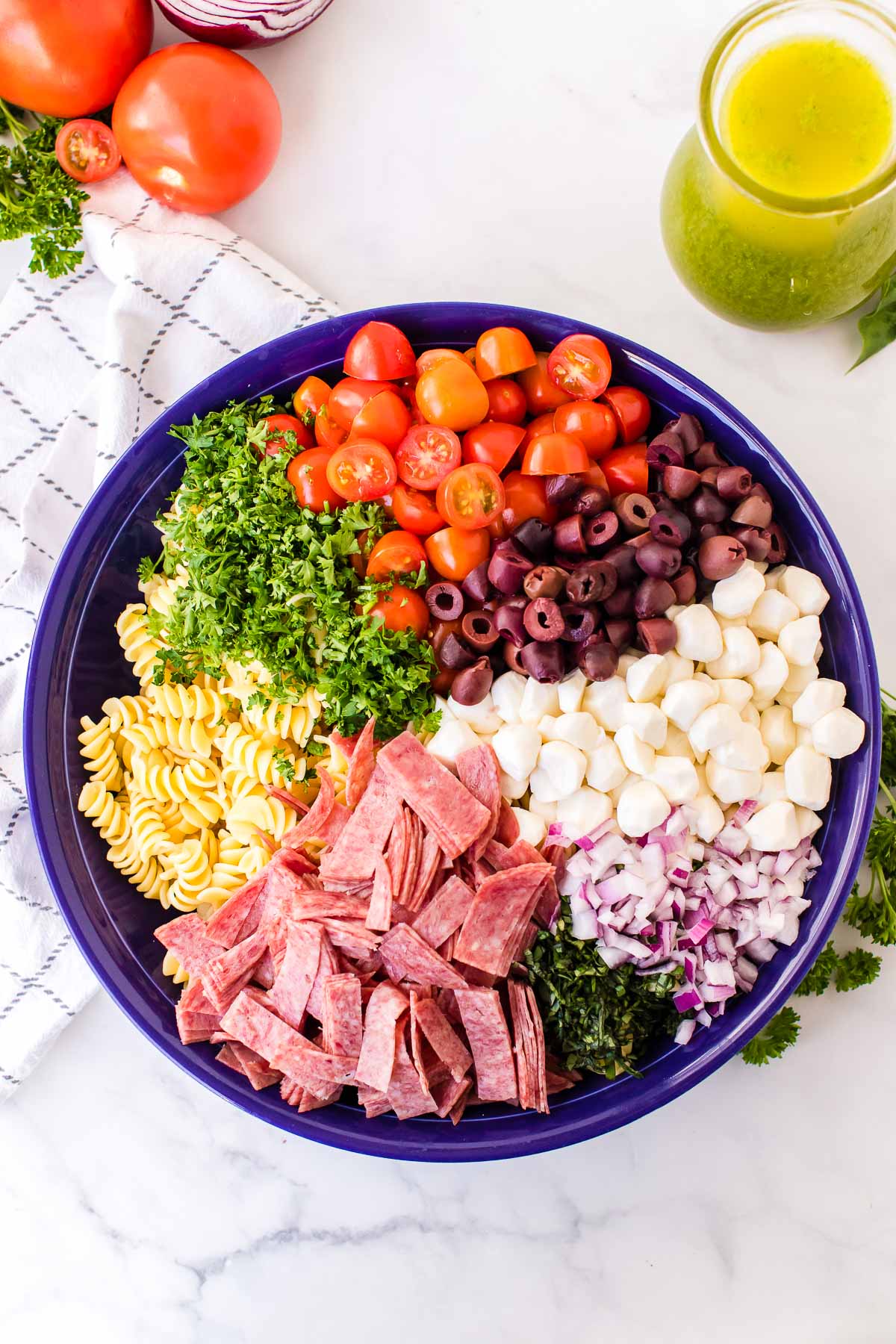 Italian Pasta Salad ingredients in a bowl before tossing