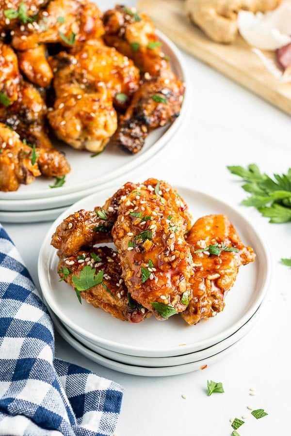 sticky grilled chicken wings serving on white plate side view 
