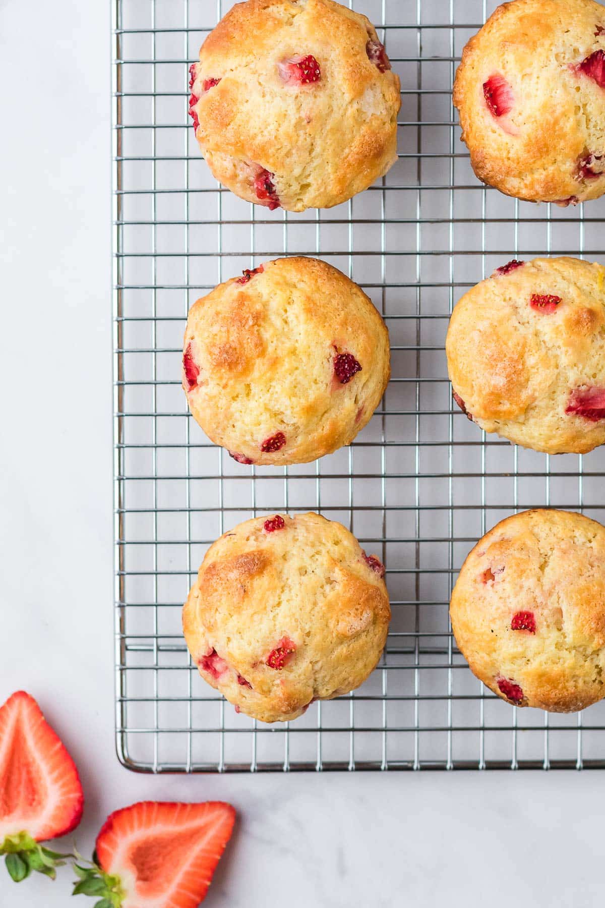 baked strawberry muffins on cooling rack