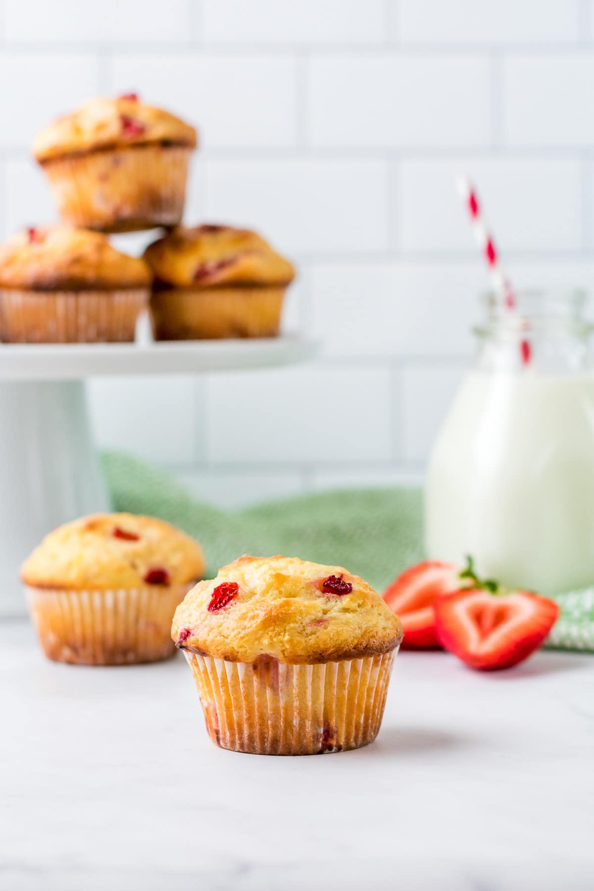 strawberry muffins with milk in background 