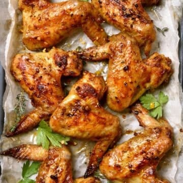 grilled chicken wings on a platter (title image for Chicken Marinade)