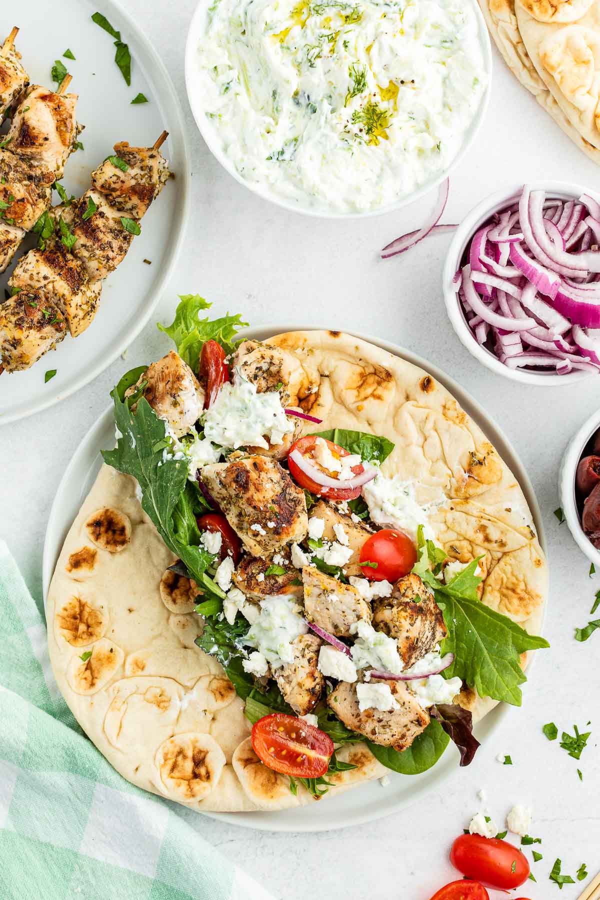 Grilled Chicken Souvlaki on soft flatbread bread with vegetables and feta cheese