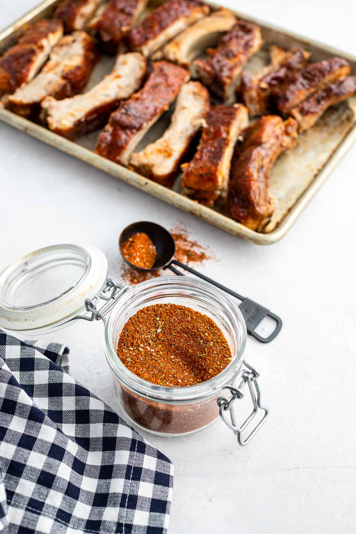 baking sheet of baby back ribs and dry rub for ribs