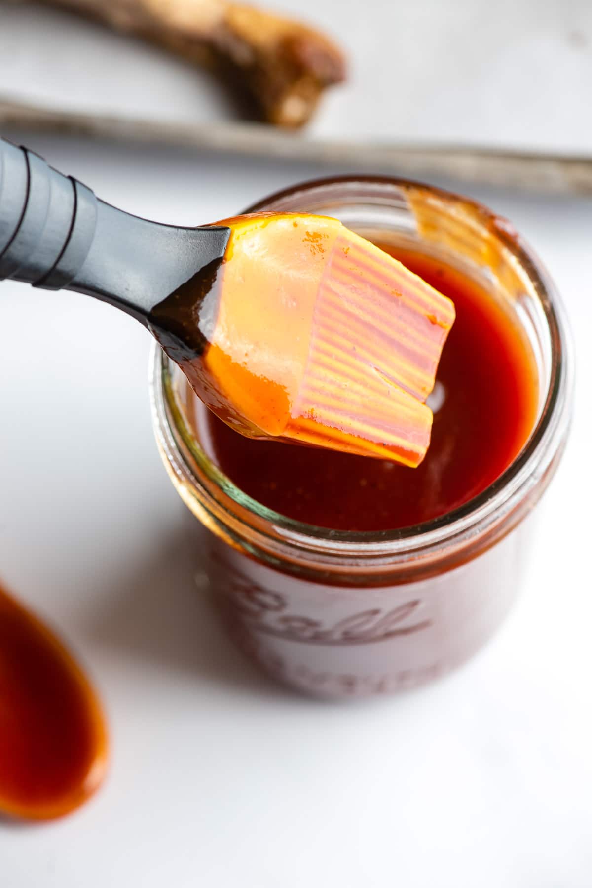 barbecue sauce in jar with basting brush