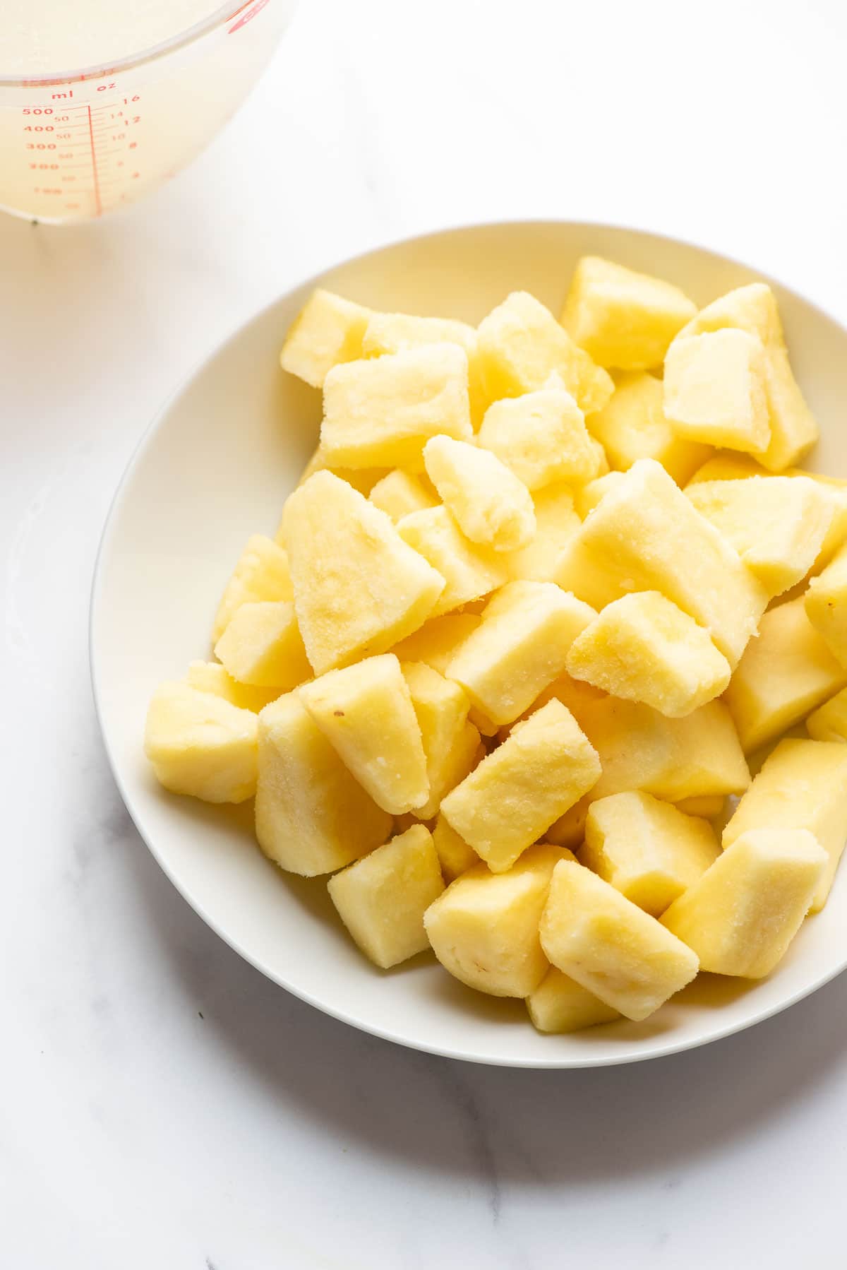 white bowl of frozen pineapple