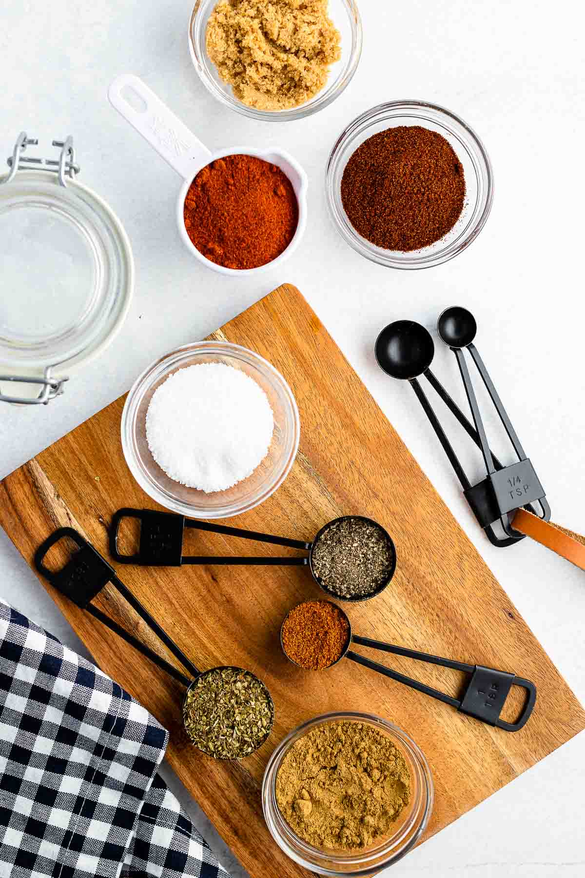 ingredients for dry rub for ribs in small bowls and measuring spoons