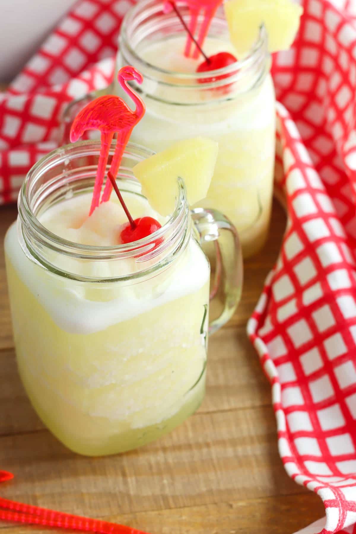 pineapple frozen lemonade in a glass with cherry