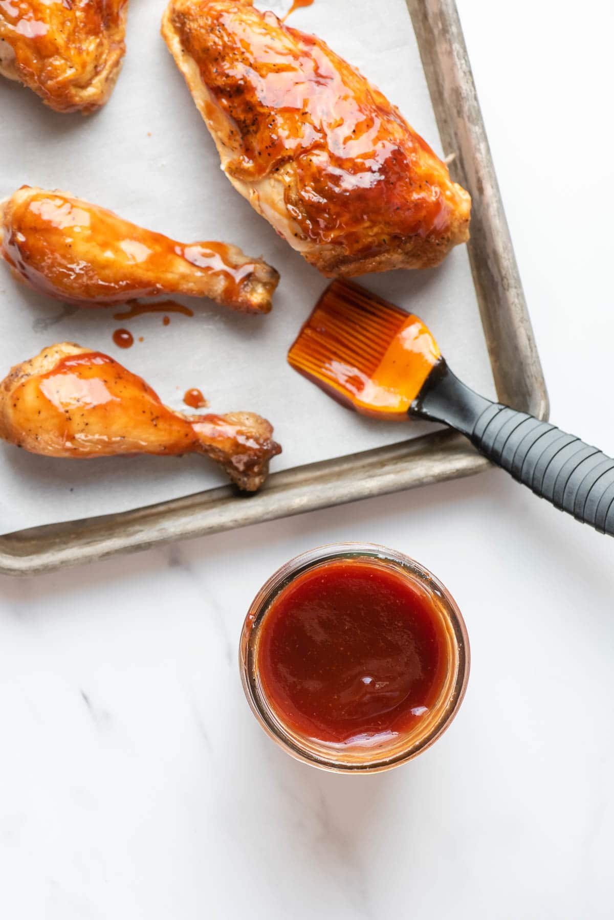 homemade barbecue sauce in jar with chicken