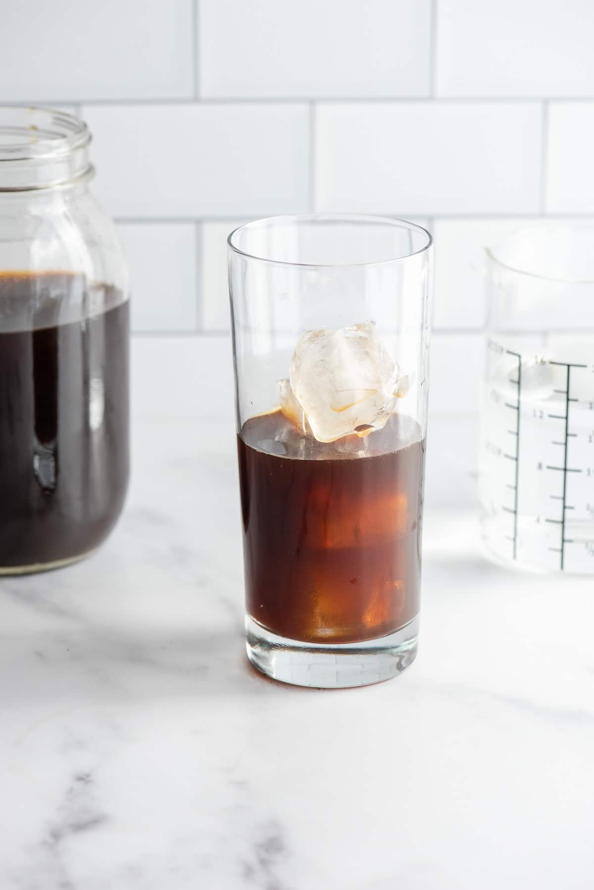 Making Cold Brew Coffee from homemade coffee concentrate in a glass with ice