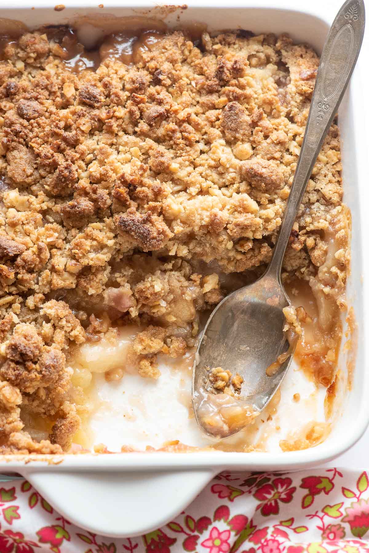 cooked peach crumble with scoop out 