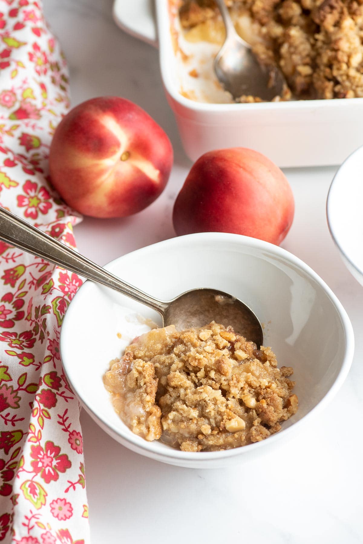 cooked peach crumble in a bowl 