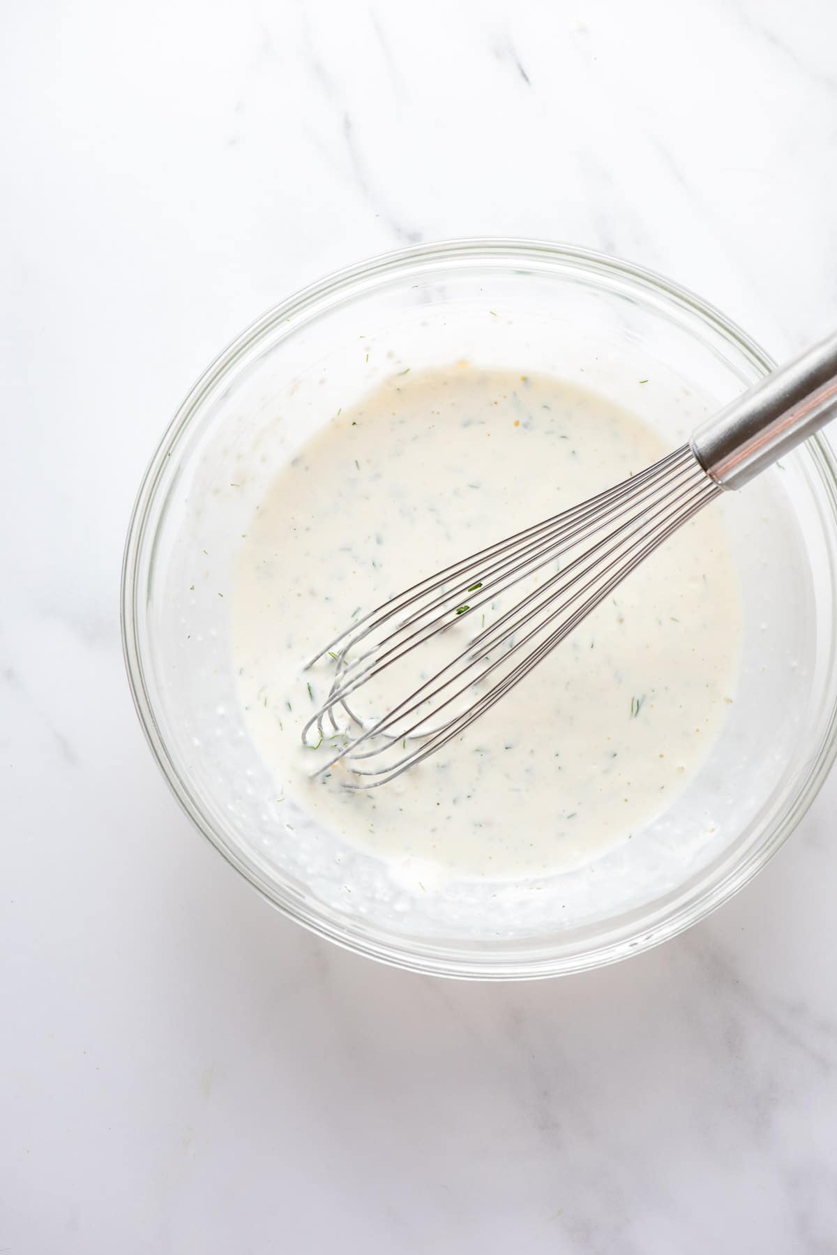 buttermilk ranch dressing just whisked in a glass mixing bowl