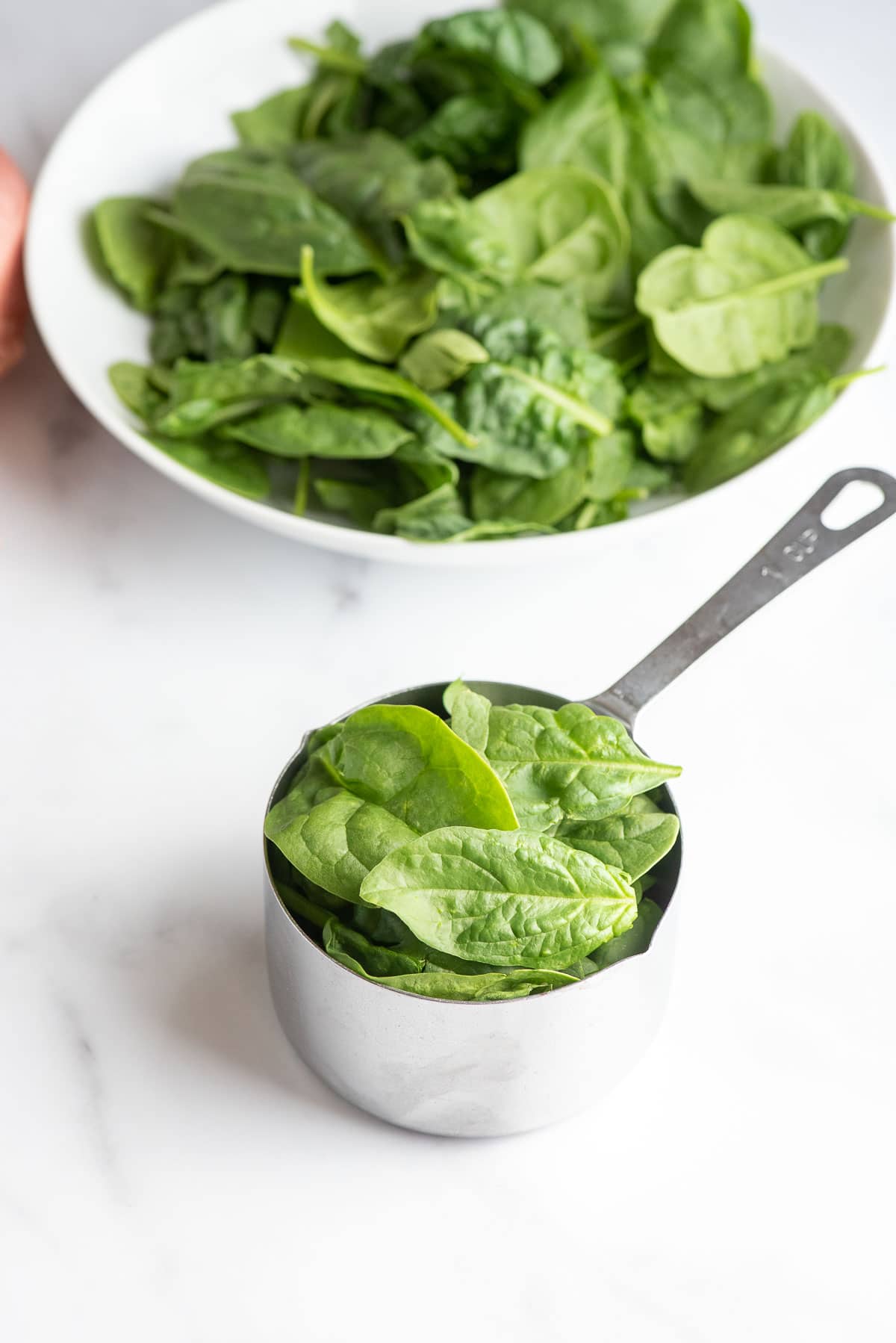 measuring cup of spinach 