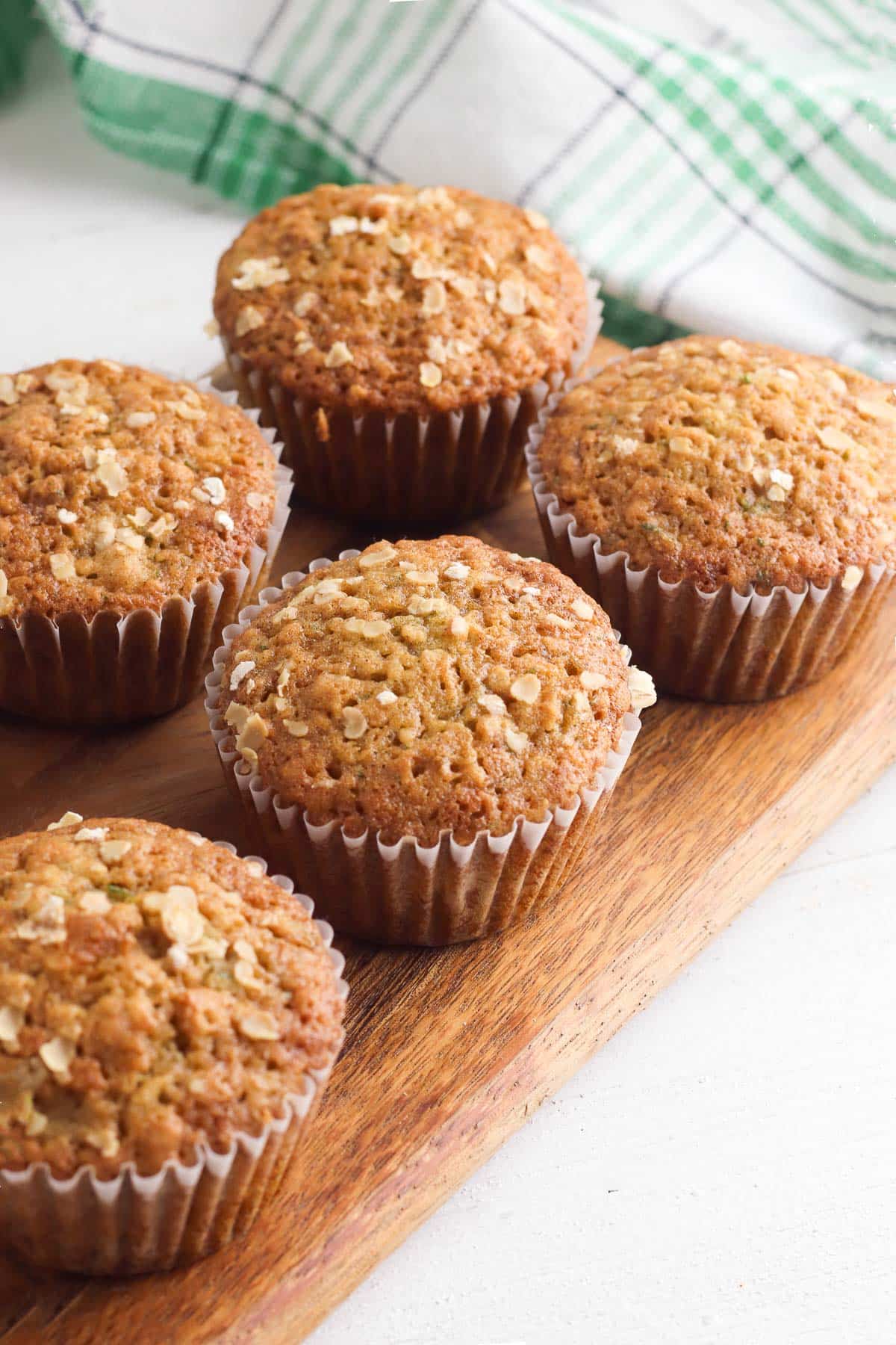 zucchini muffins on a wood cutting board