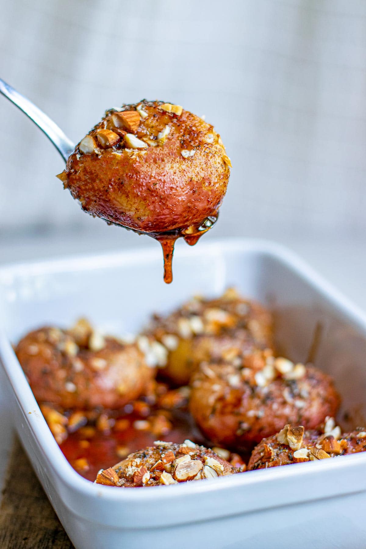 baked donut peaches on serving spoon 