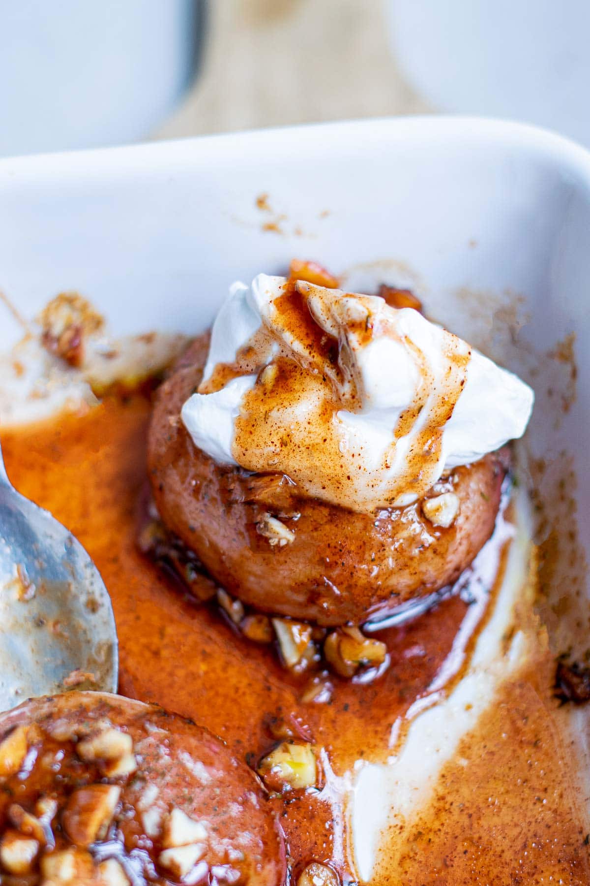 baked donut peaches with whipped cream in pan 