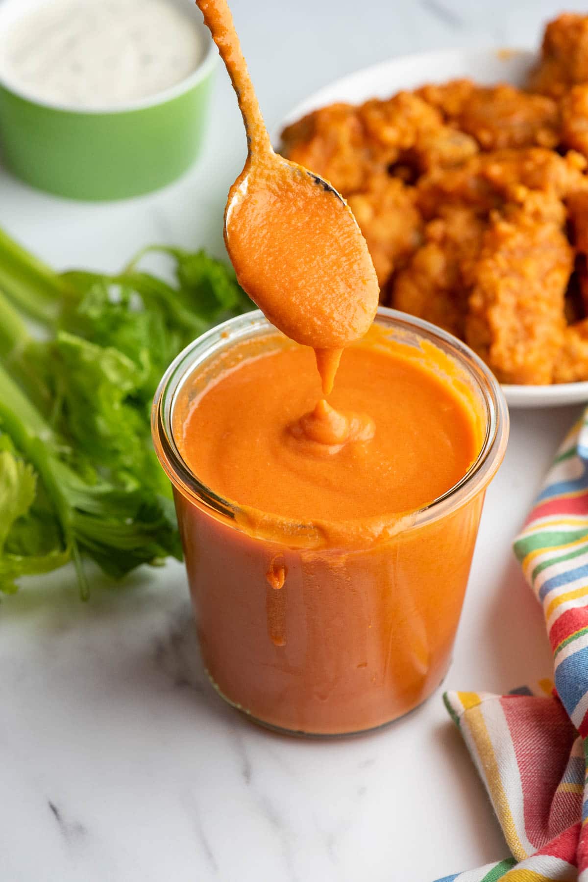 buffalo sauce dripping off spoon