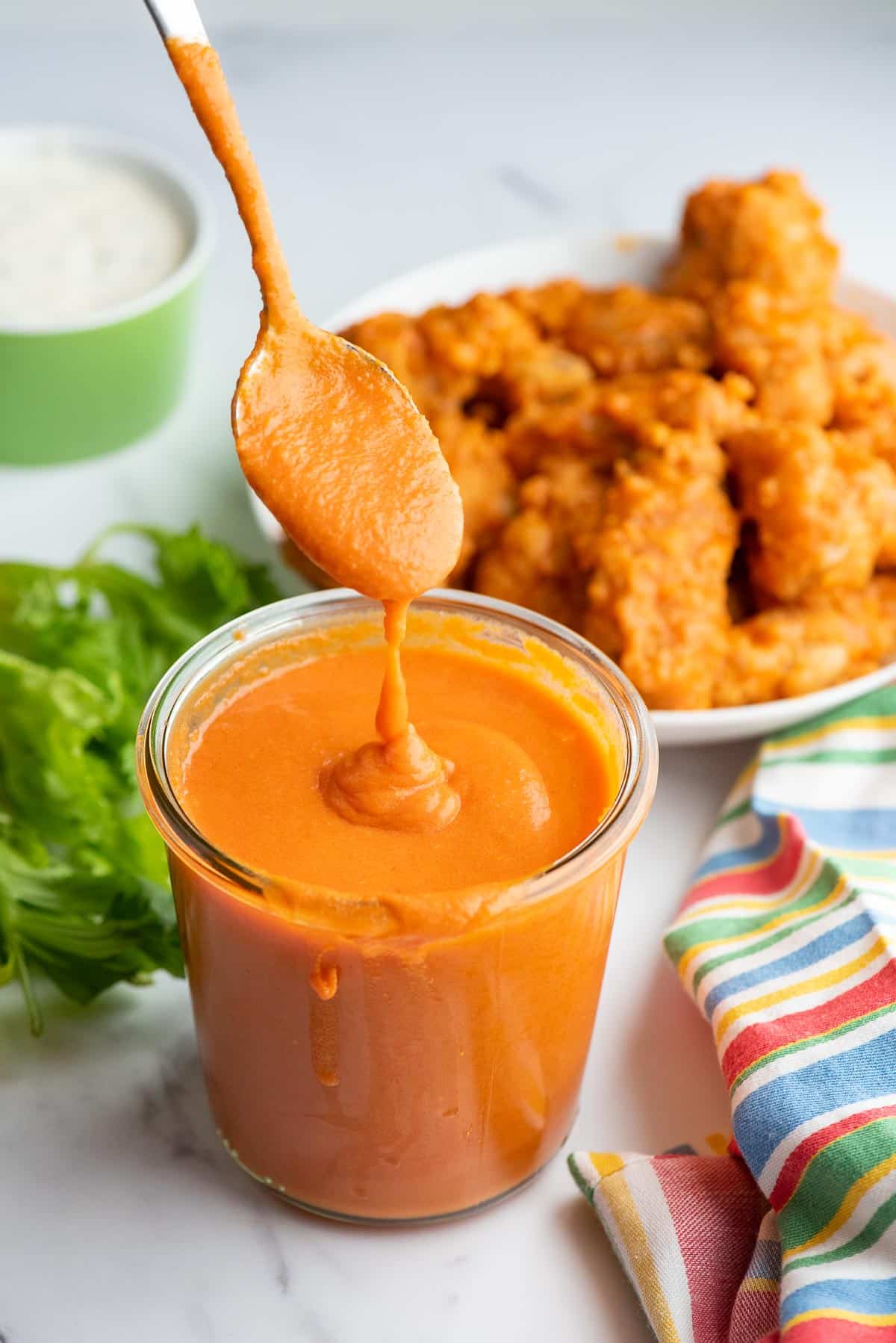 buffalo sauce dripping off spoon