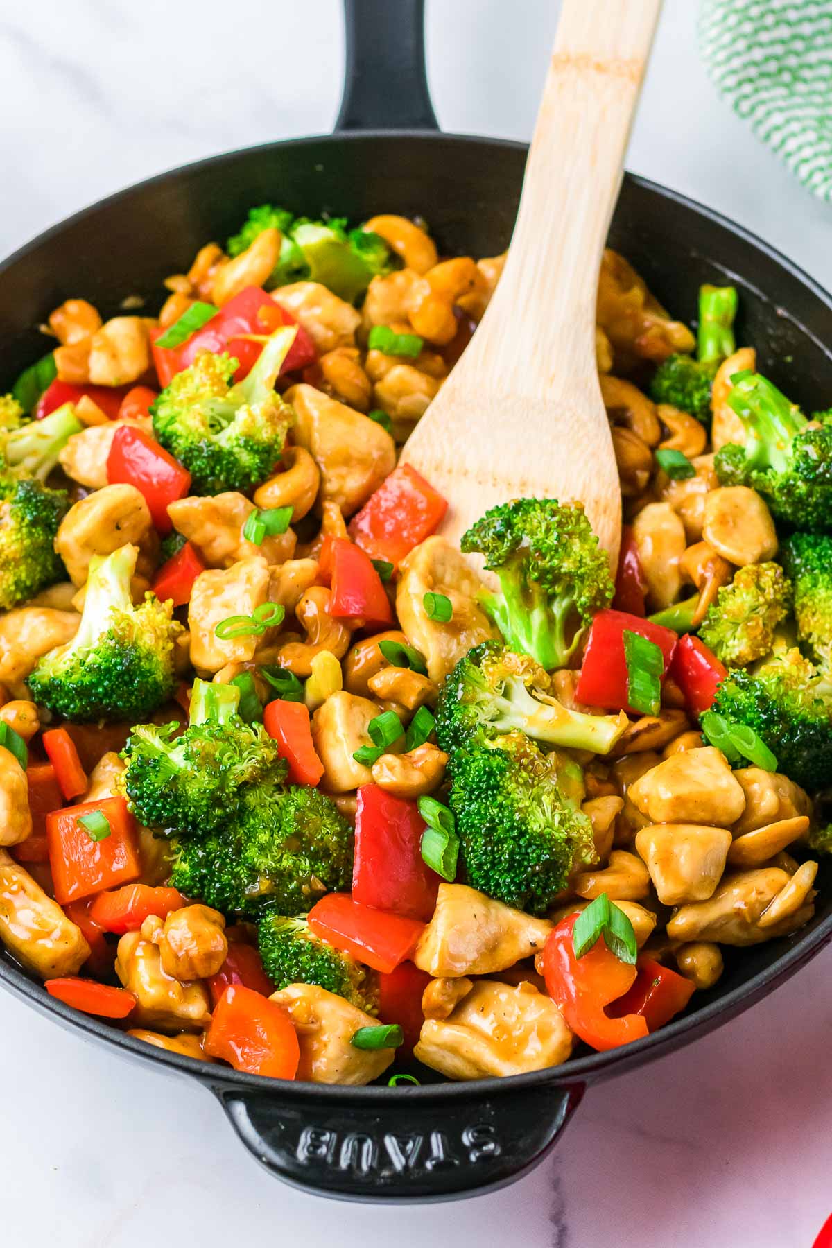 cashew chicken in skillet cooking 