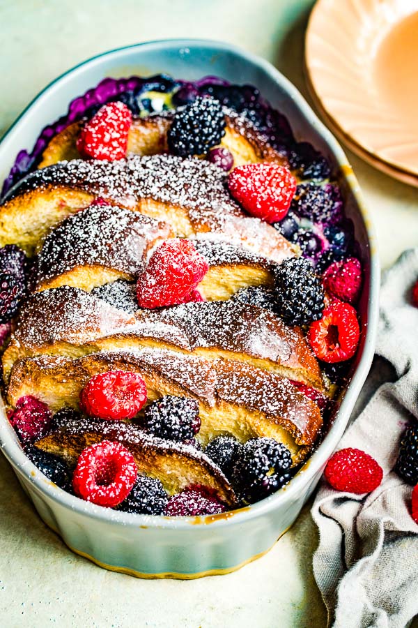 challah french toast with berries dusted with powdered sugar