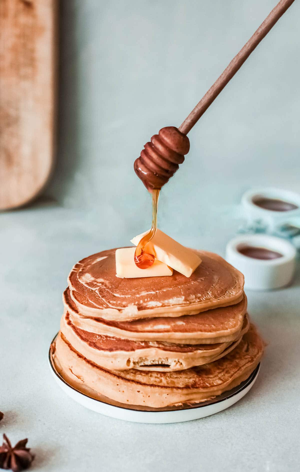 stack of apple pancakes with butter and honey