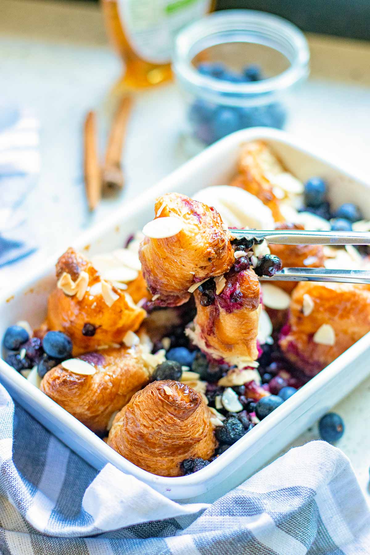 baked croissant french toast with tongs 