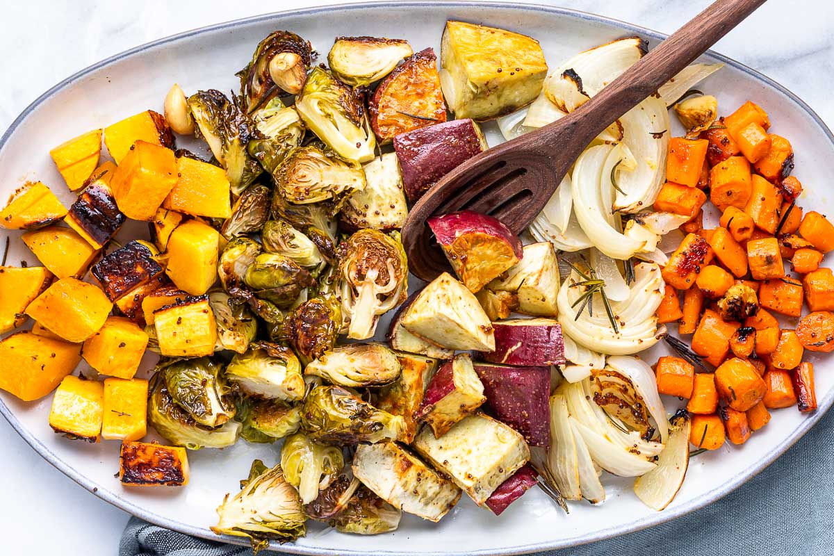 oven roasted vegetables on platter with spoon