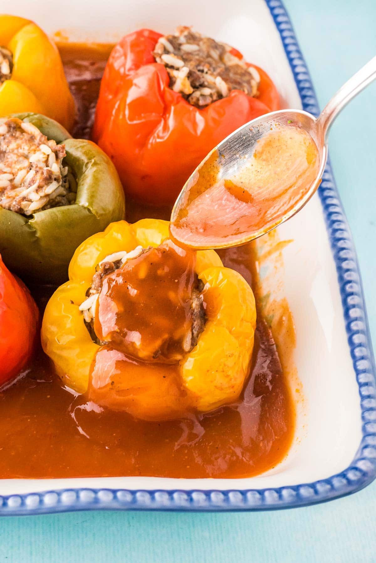 tomato sauce spooned over instant pot stuffed peppers