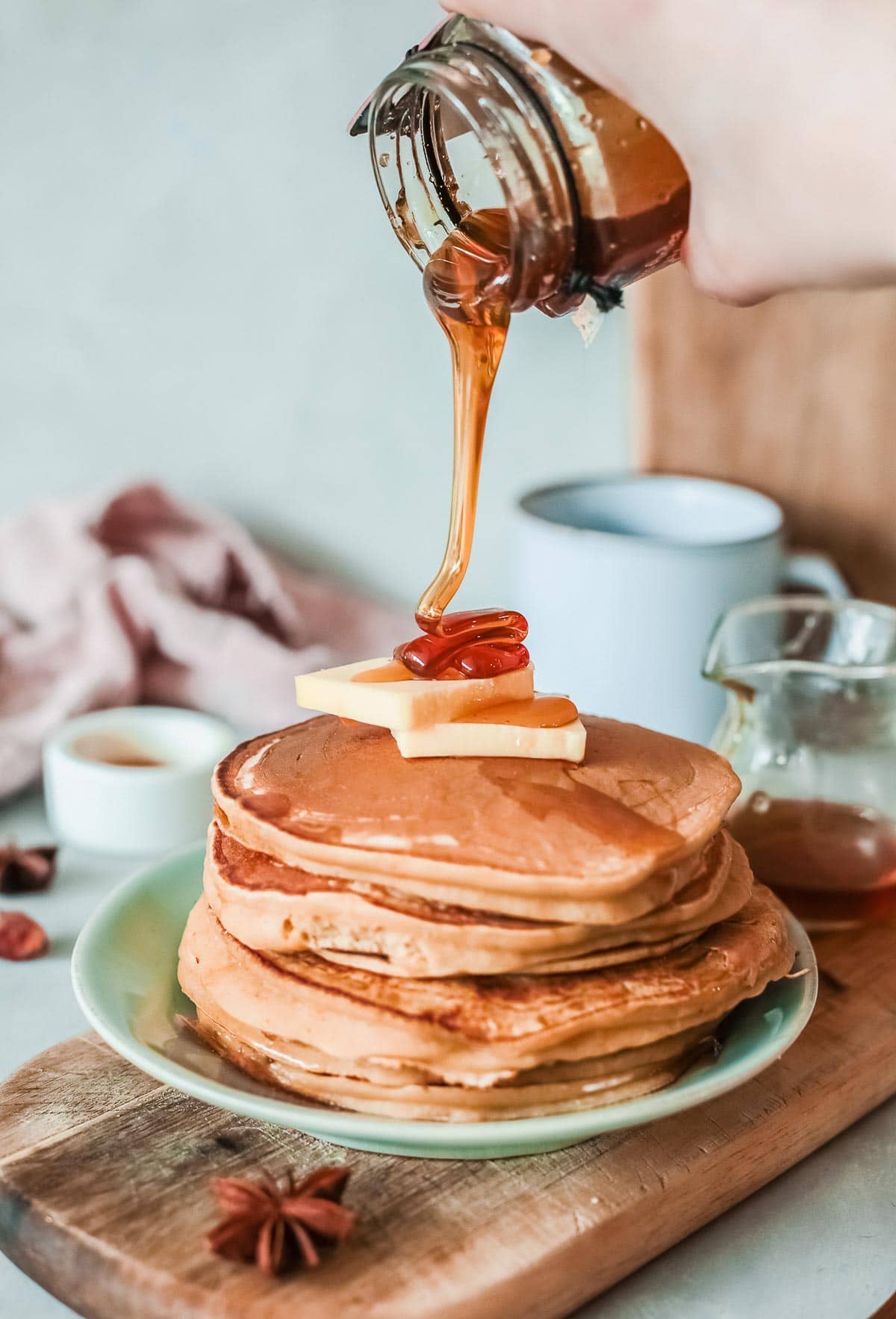 stack of apple pancakes [pouring syrup