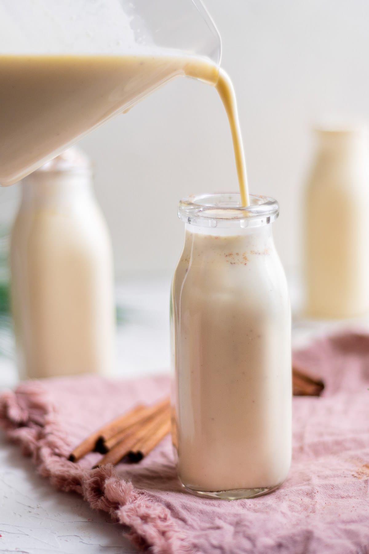 pouring eggnog into bottle 