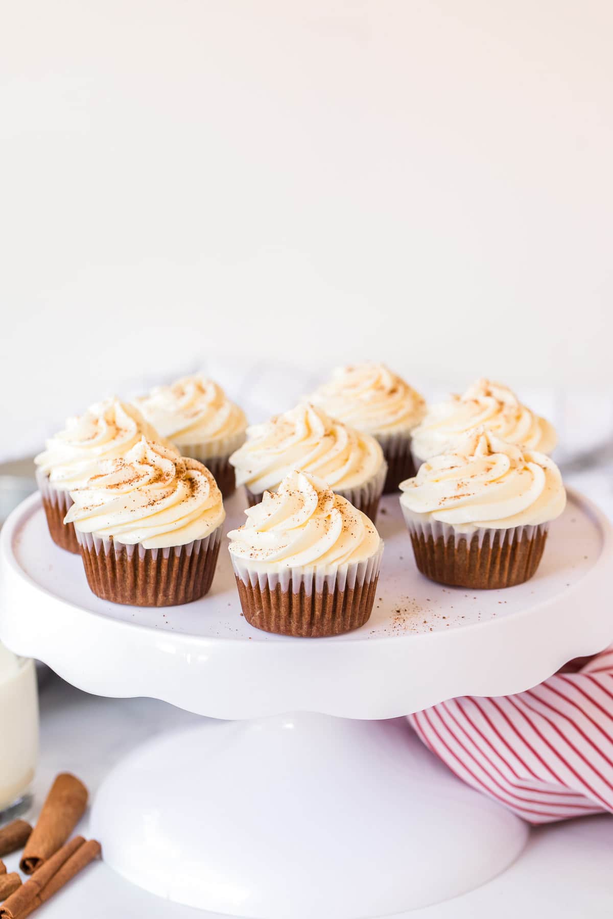 gingerbread cupcakes with eggnog frosting on cake pedestal