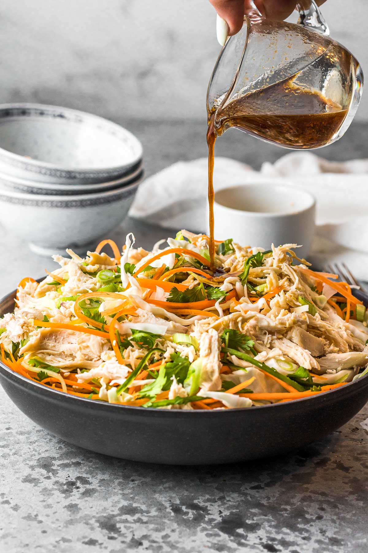 Asian Chicken Salad pouring dressing 