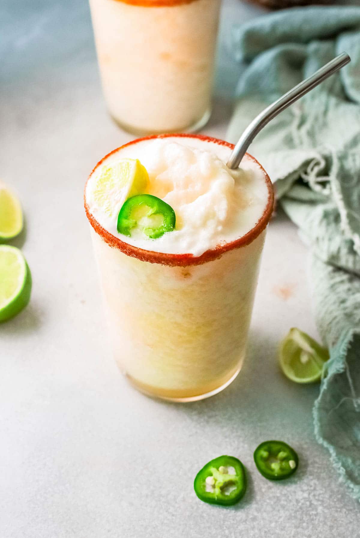 frozen pineapple margaritas in a rimmed glass