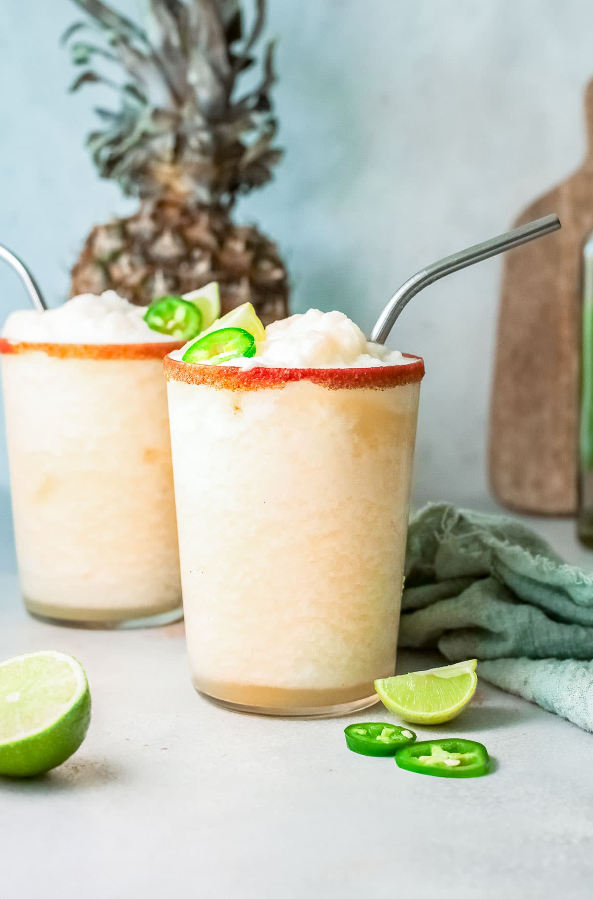 frozen pineapple margaritas in a rimmed glass side