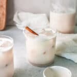 horchata in glasses with cinnamon stick