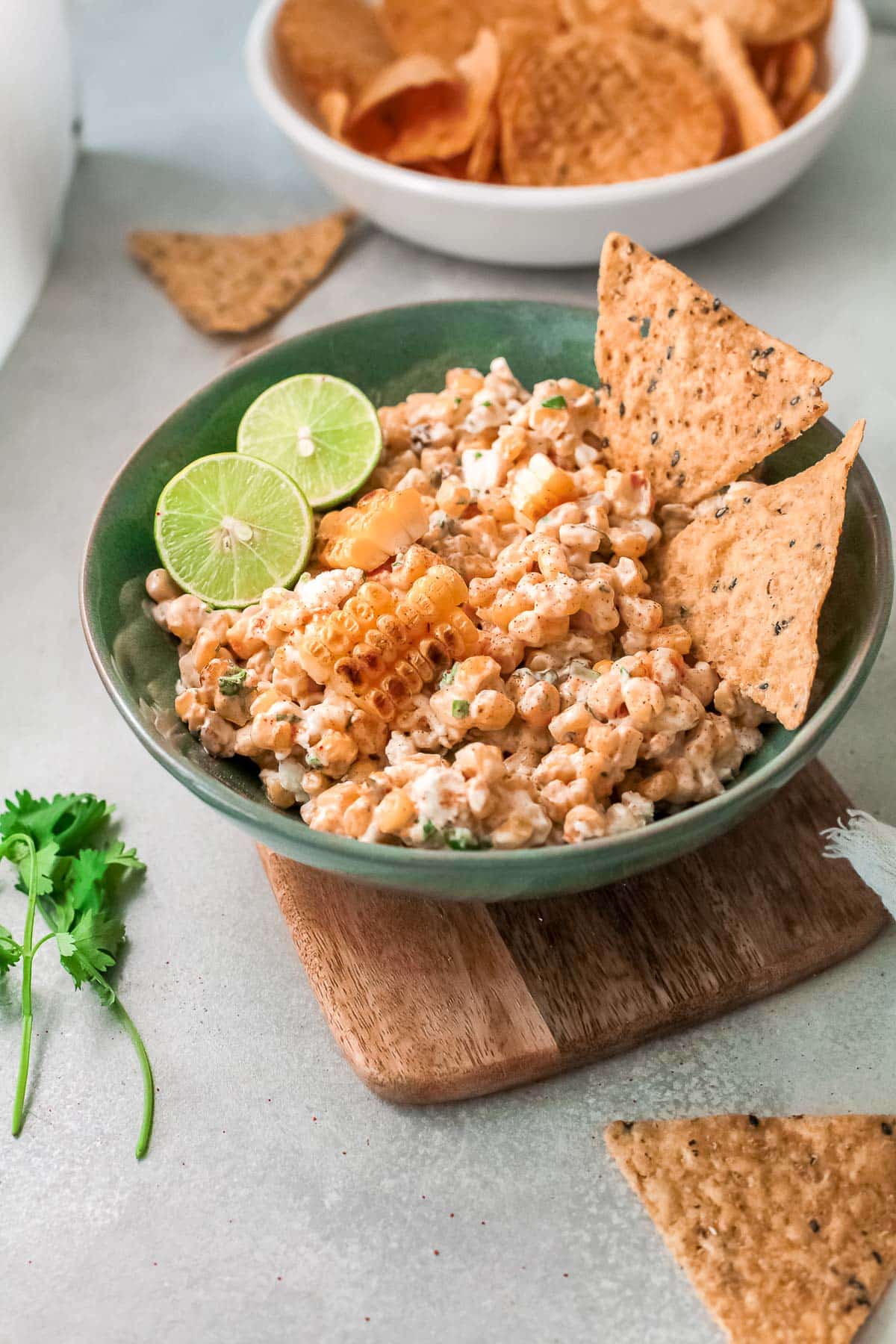 mexican corn dip in a bowl with chips 