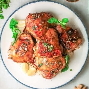 cooked vietnamese chicken thighs on plate overhead square image