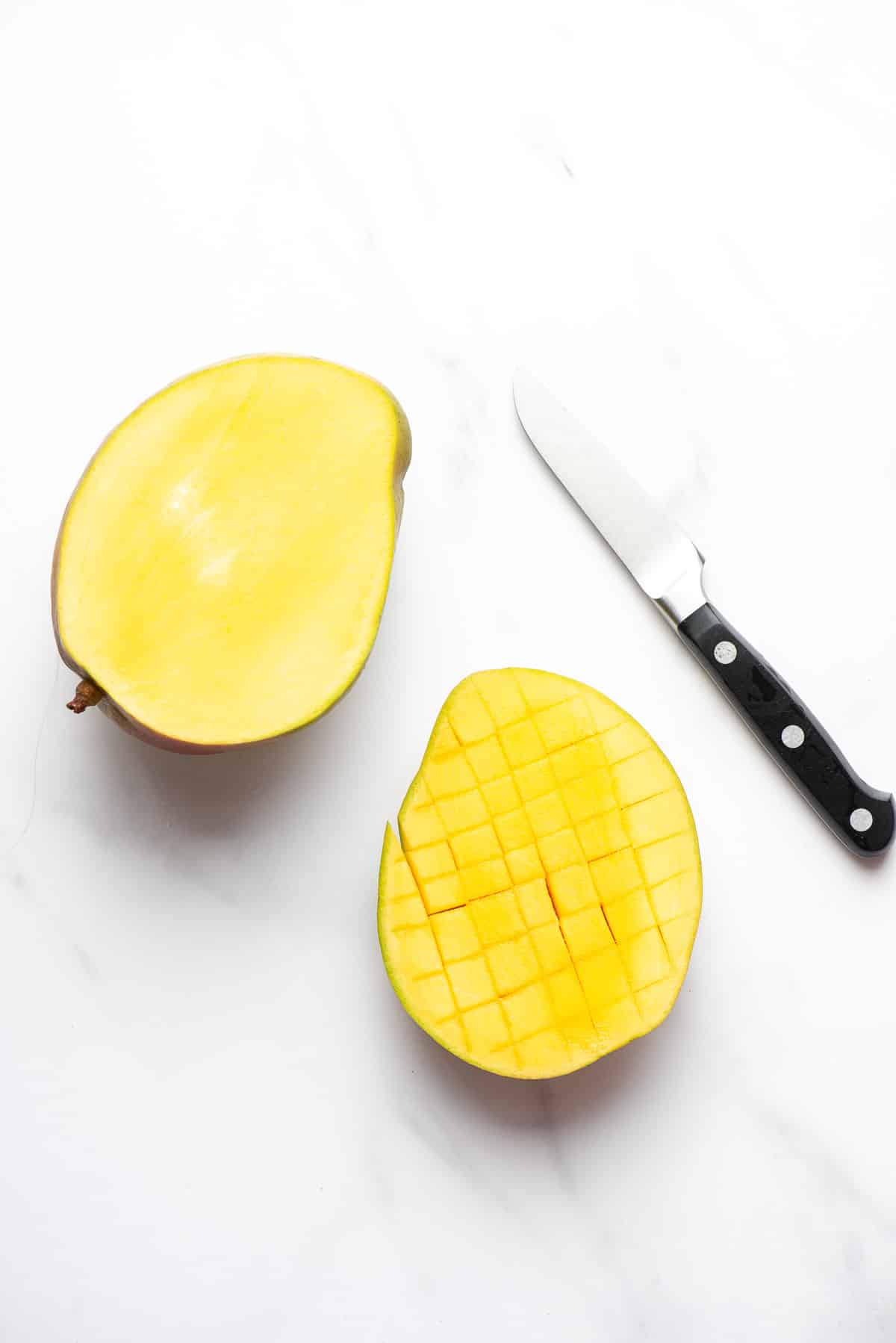 cut side of mango with scored fruit