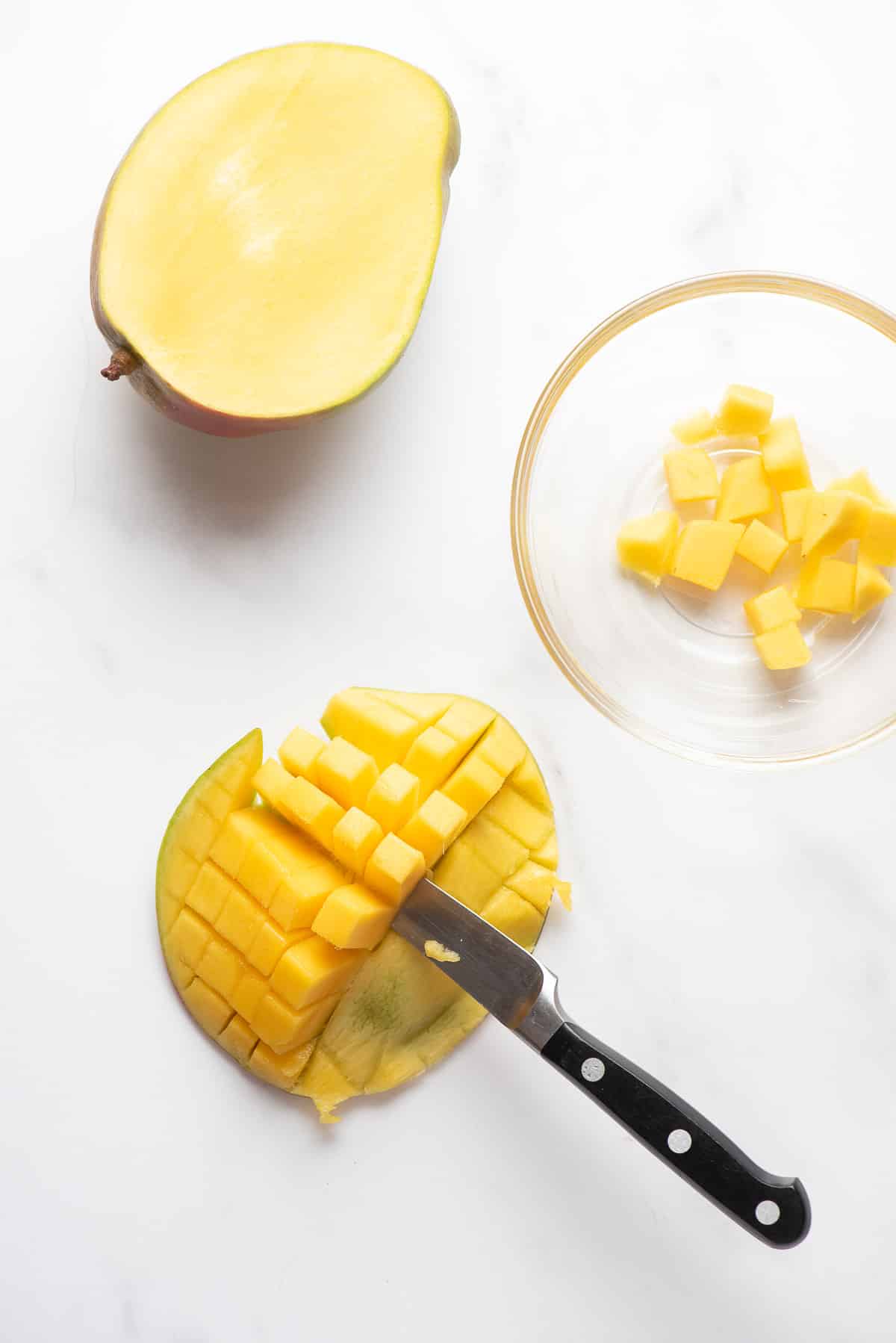 cutting mango fruit from the skin