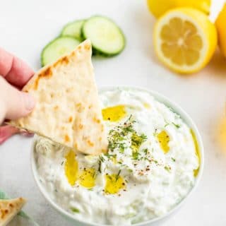 Tzatziki Sauce with a pita wedge being dipped title image