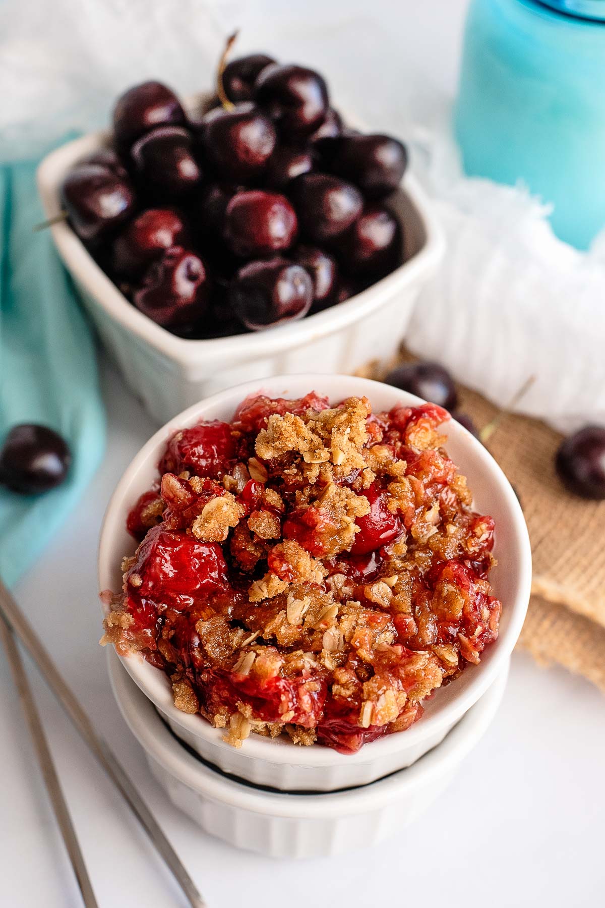 cherry crisp serving with cherries in background 